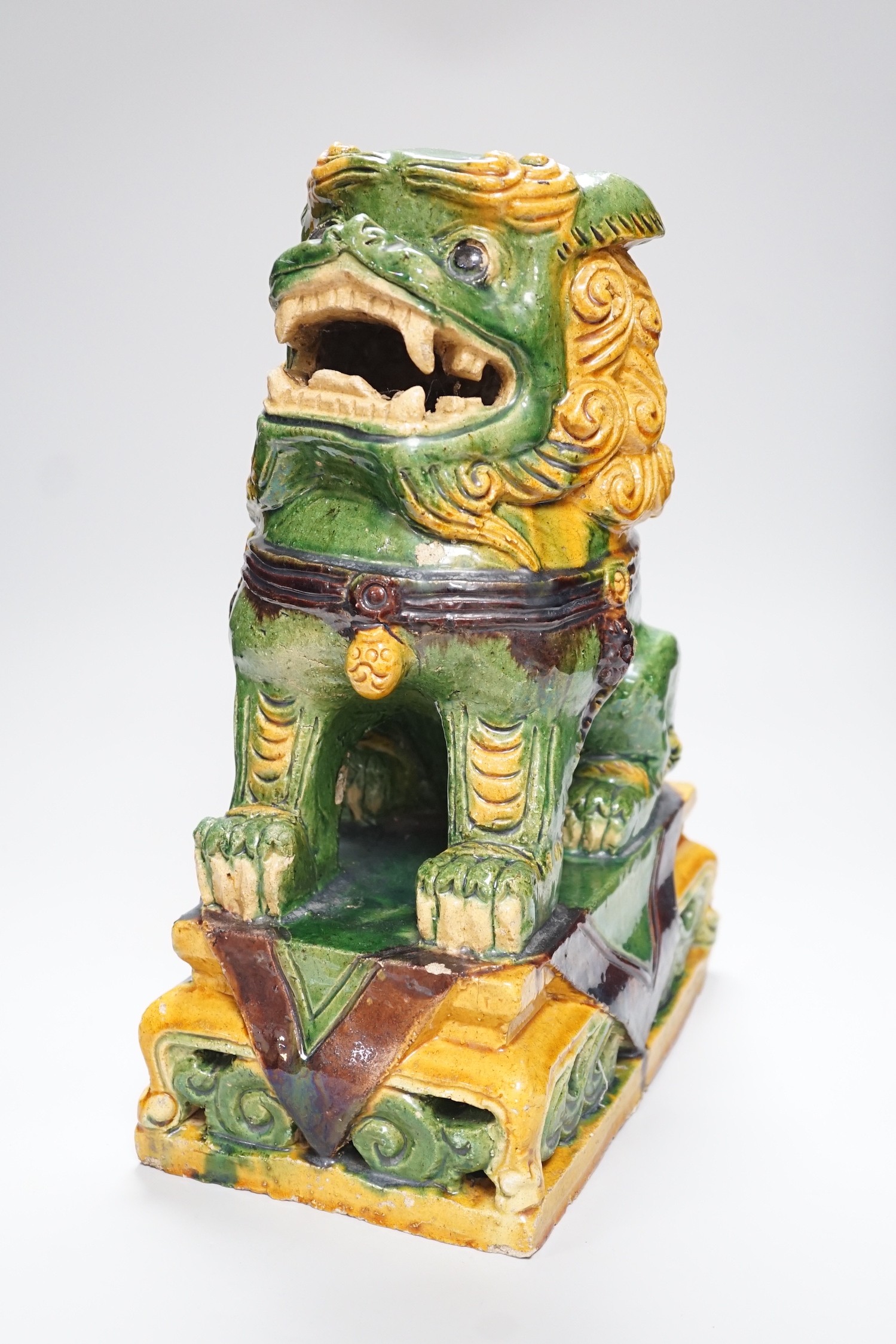 A large Chinese sancai glazed lion dog, 38cms high